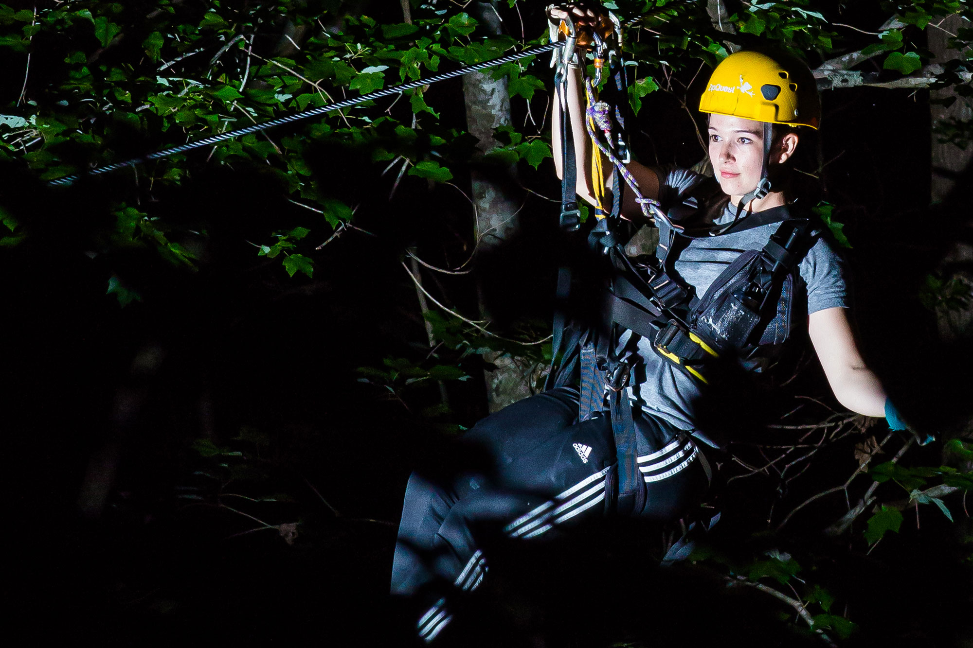 Woman on Nightquest Nighttime Zipline adventure